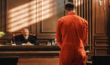 Man standing in front of judge in courtroom